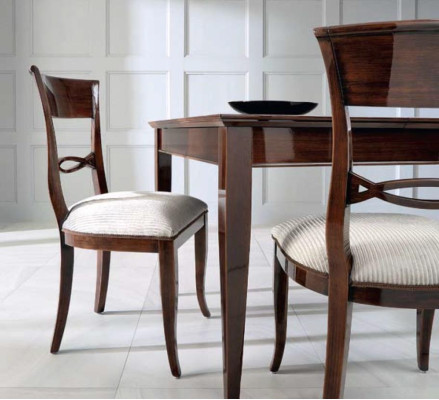 Elegant dining table with chairs in dark brown color with shiny surface