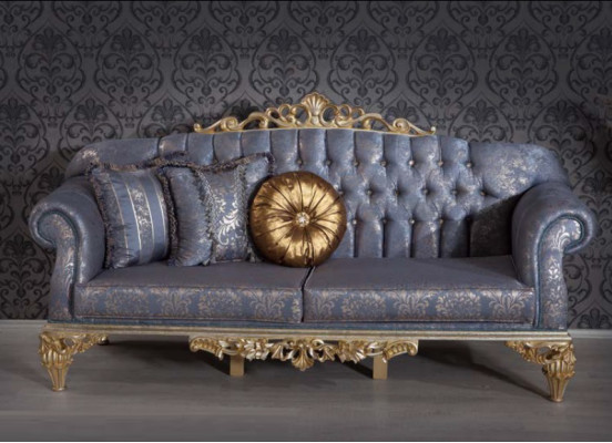 Sophisticated Classic sofa in Chesterfield design for the living room with golden cushions