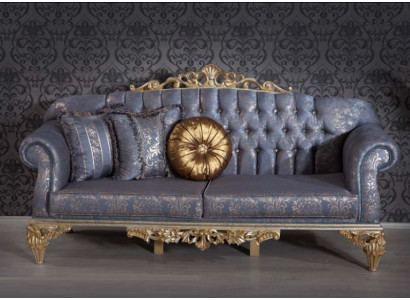 Sophisticated Classic sofa in Chesterfield design for the living room with golden cushions
