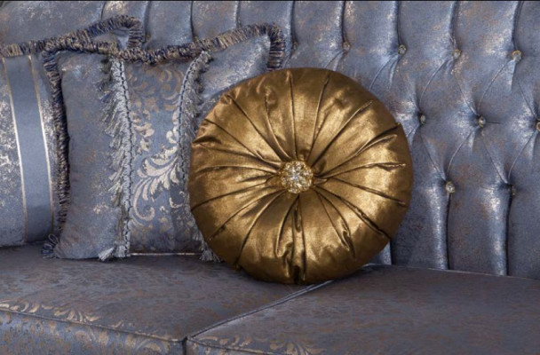 Sophisticated Classic sofa in Chesterfield design for the living room with golden cushions