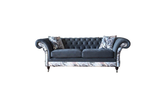 A striking three-seater sofa in a Chesterfield design with delicate gray floral decoration