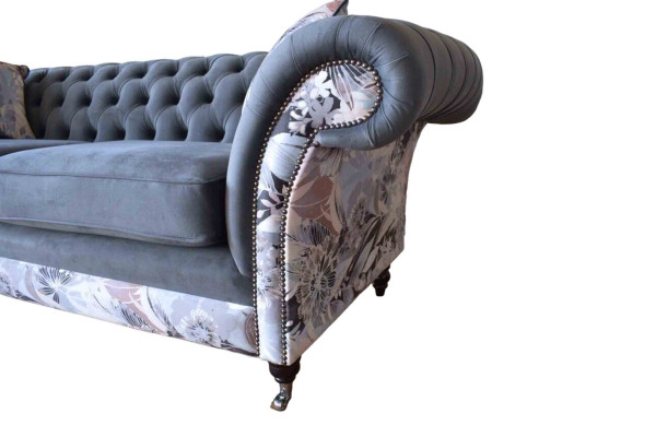 A striking three-seater sofa in a Chesterfield design with delicate gray floral decoration