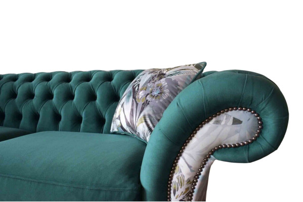 A vibrant three-seater Chesterfield sofa in a delicate emerald color with a floral pattern