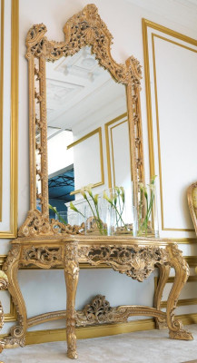Luxurious carved console table and mirror in an elegant frame