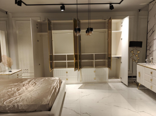 Luxurious bedroom furniture set: bed, 2 bedside tables and wardrobe