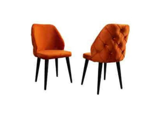 Upholstered wooden chair orange Chesterfield on black legs in the dining room