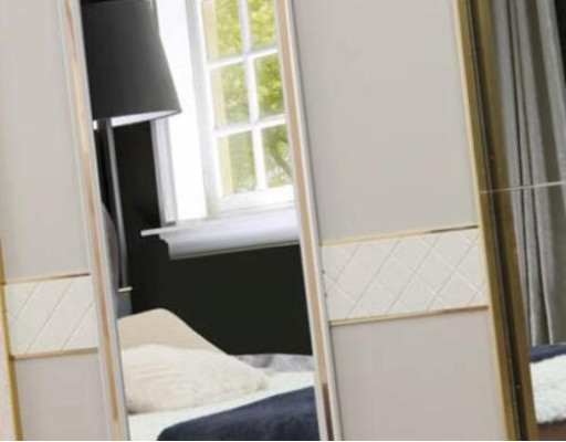 Luxury wardrobe with gold-plated accents and mirrors