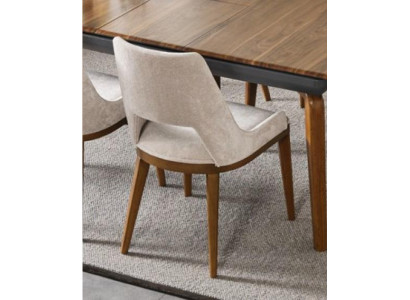 A laconic, modern chair with high wooden legs and upholstery in a pleasant, light cream color for the dining room