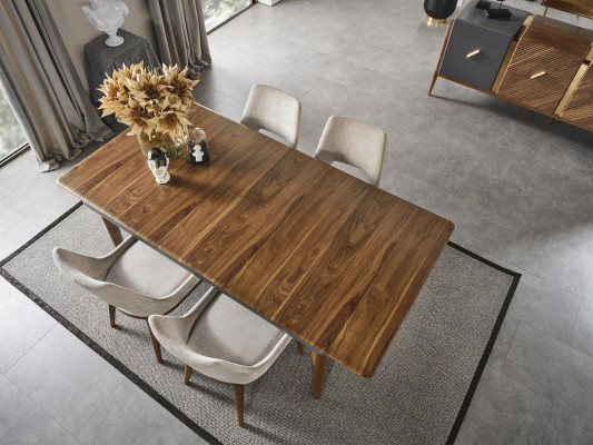 A laconic, modern chair with high wooden legs and upholstery in a pleasant, light cream color for the dining room