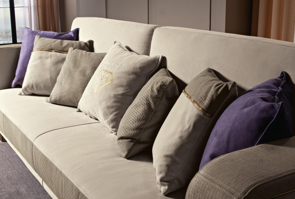Designer three-seater upholstered sofa with modern design for the living room