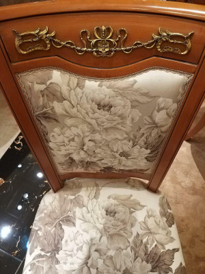 Designer chair made of solid wood with luxurious upholstery from European furniture manufacturers
