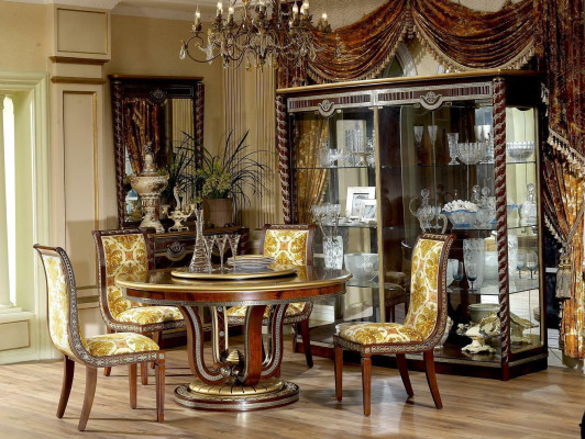 Classic r dining table in a round shape with an artistically decorated base