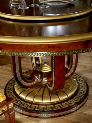 Classic r dining table in a round shape with an artistically decorated base
